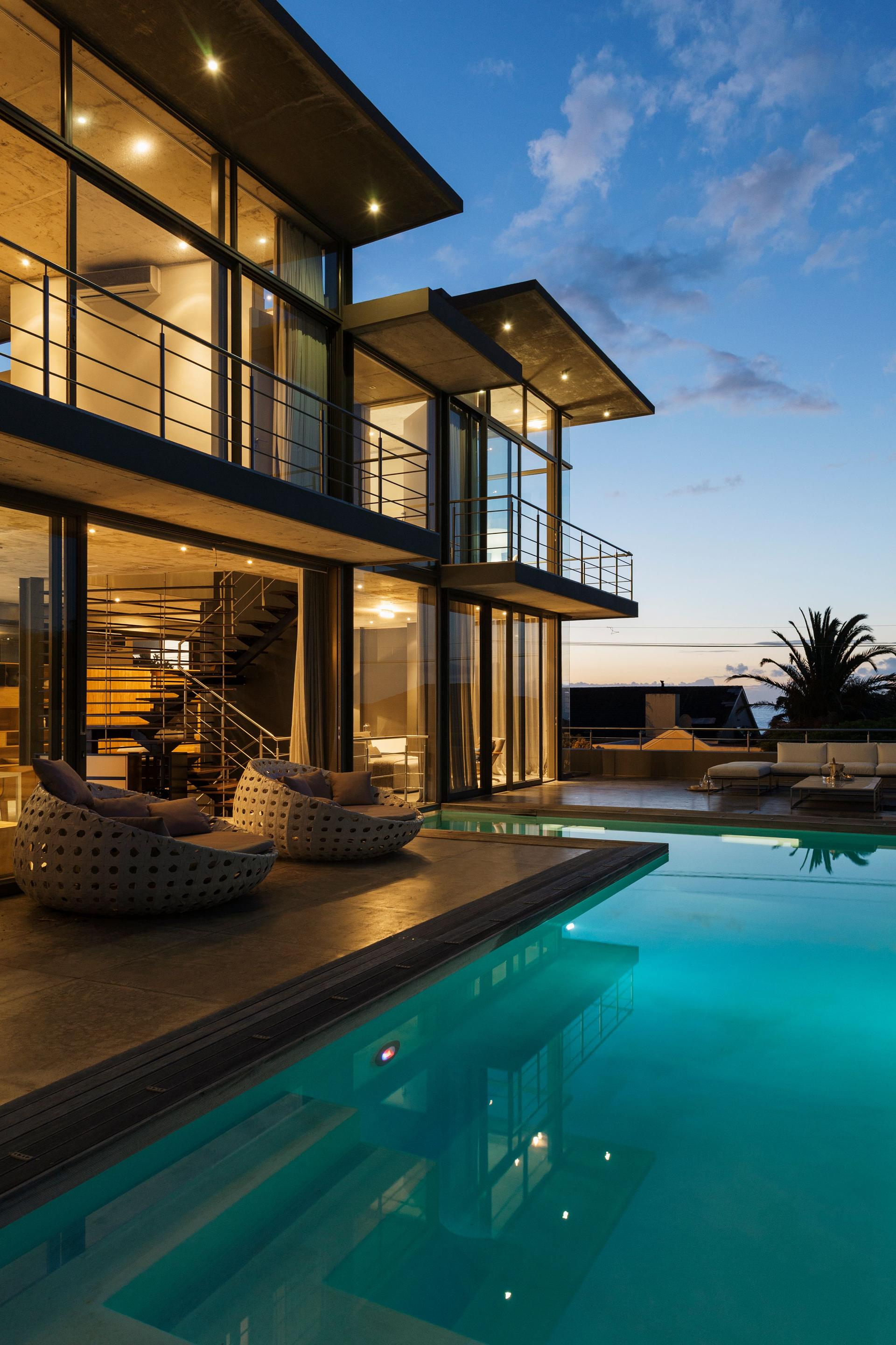 Luxury house with swimming pool illuminated at night